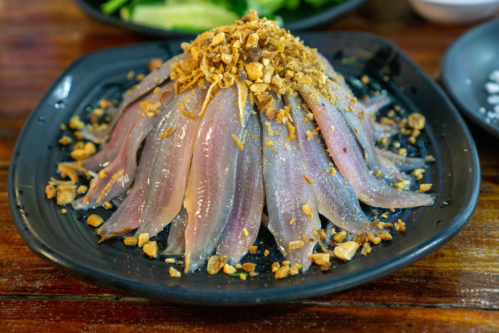 Raw Herring Salad on Raw Onions topped with Fried Onions and Peanuts in a Restaurant on Phu Quoc Island, Vietnam