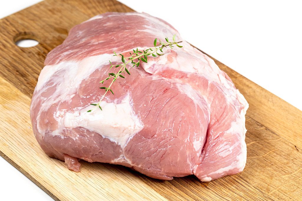 Raw meat pork on a wooden kitchen board