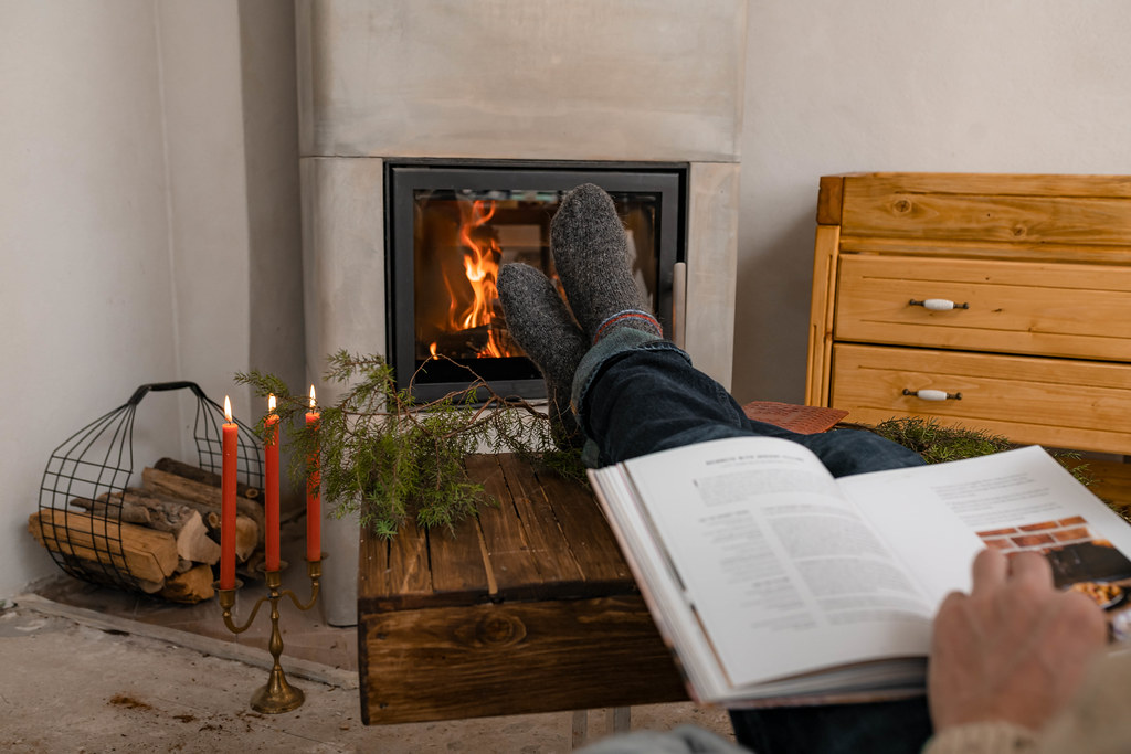 Reading Book White Resting Feet Near Fireplace