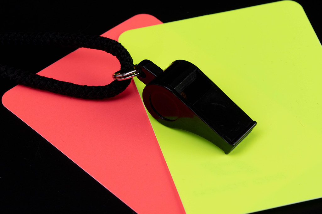 Referee cards with referee whistle on black background