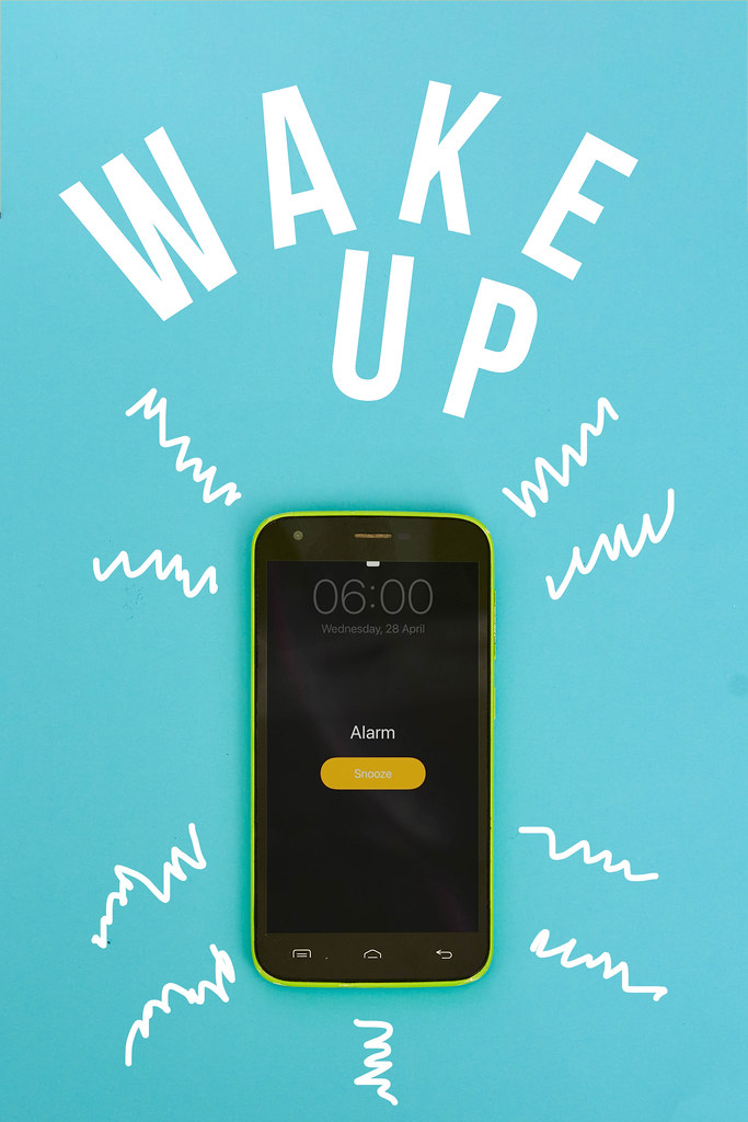 Ringing alarm clock on mobile phone with text - wake up