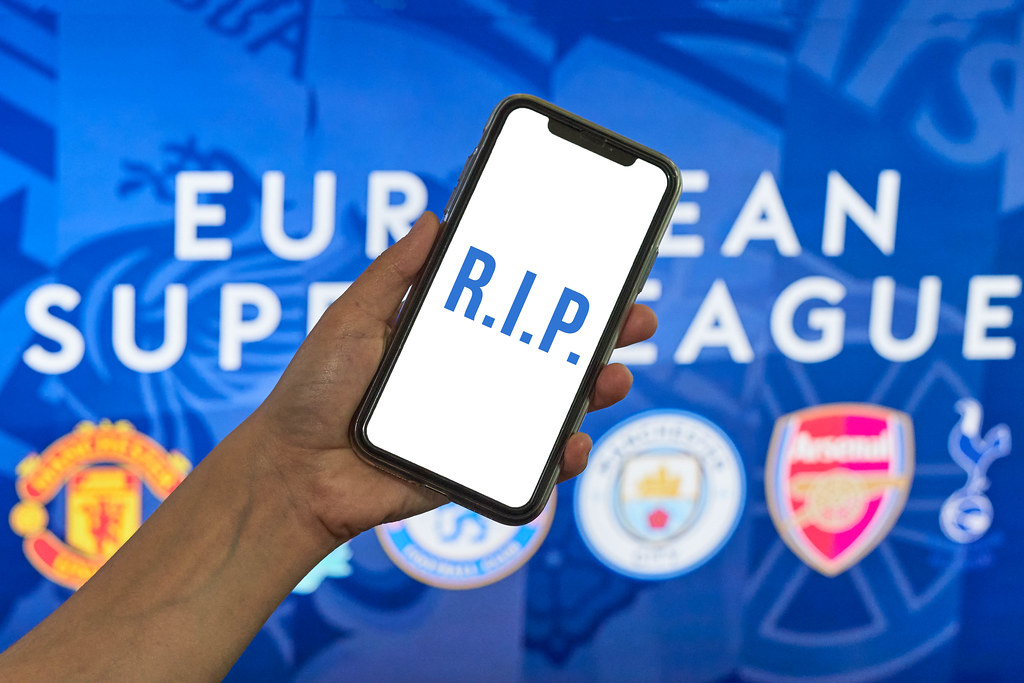 RIP text on the mobile phone screen over European super league banner