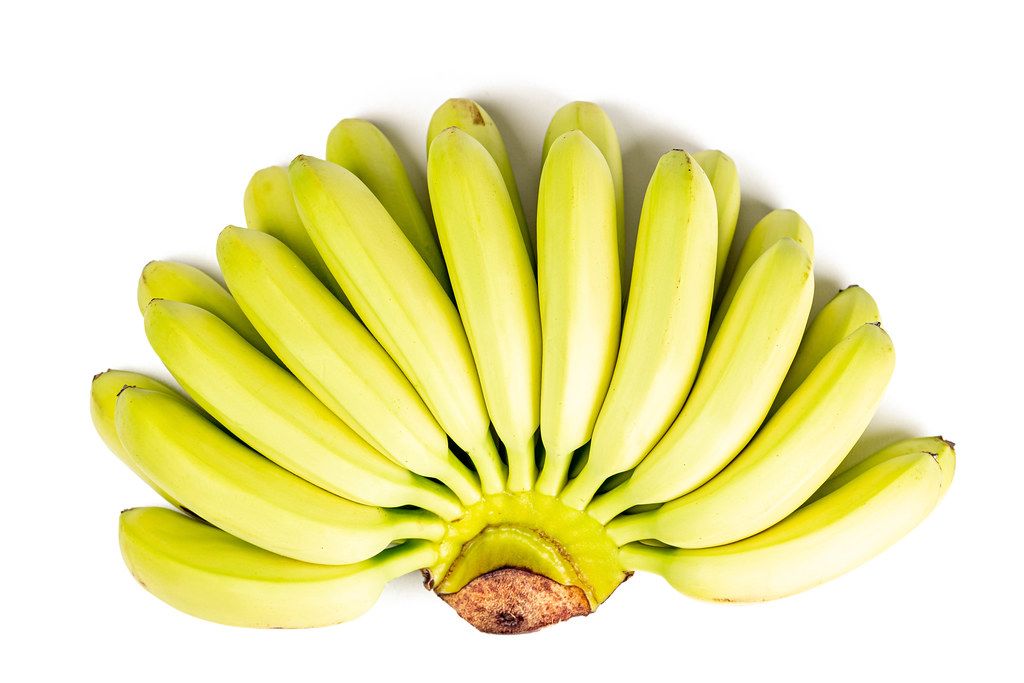 Ripe baby bananas on white, top view