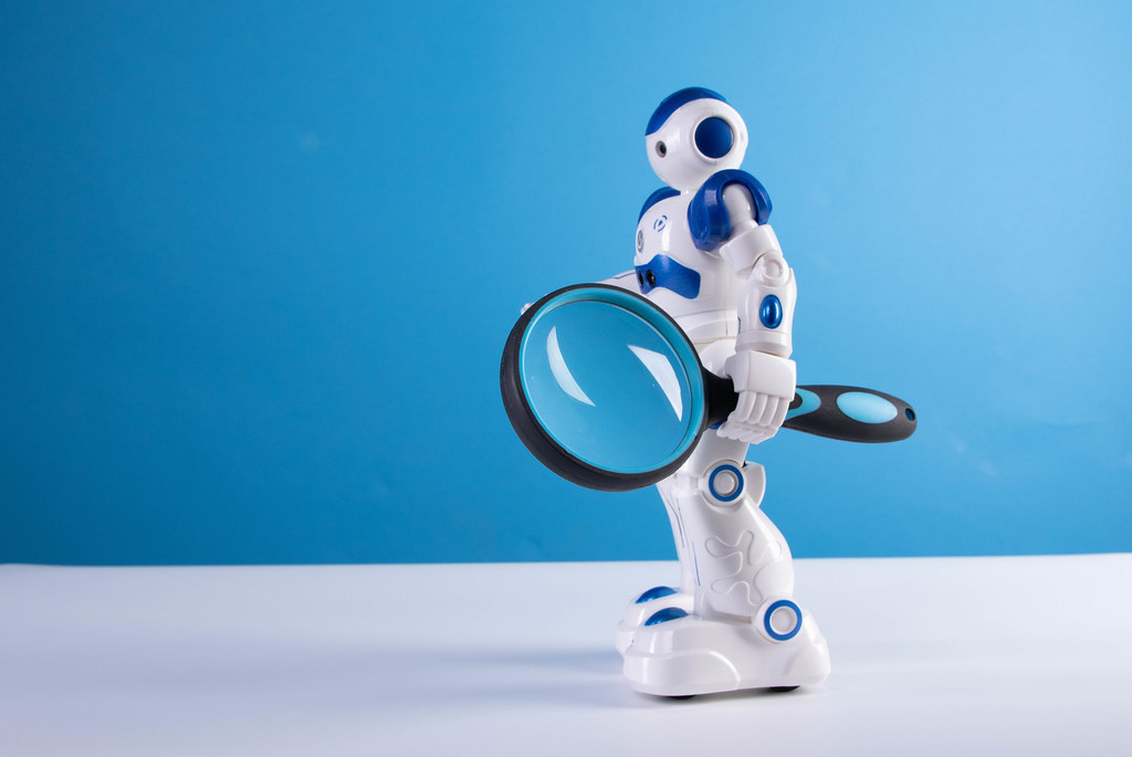 Robot holding magnifying glass