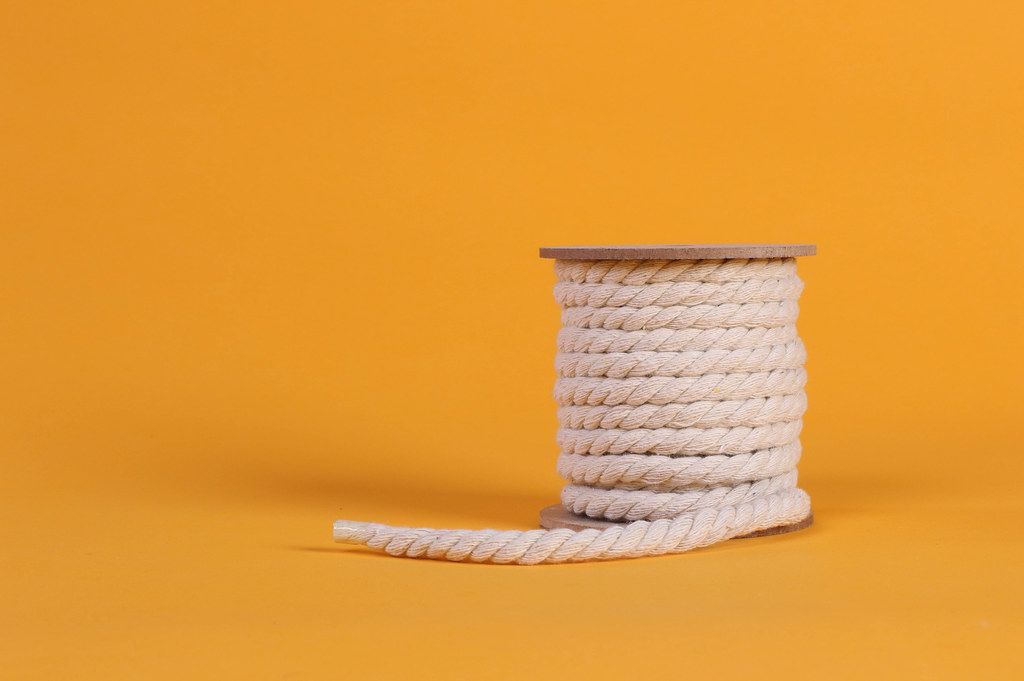 Rope roll on orange background with copy space