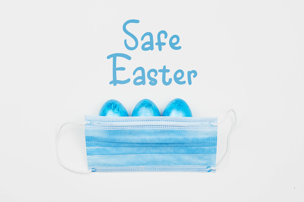 Safe Easter concept with decorated eggs and protective face mask