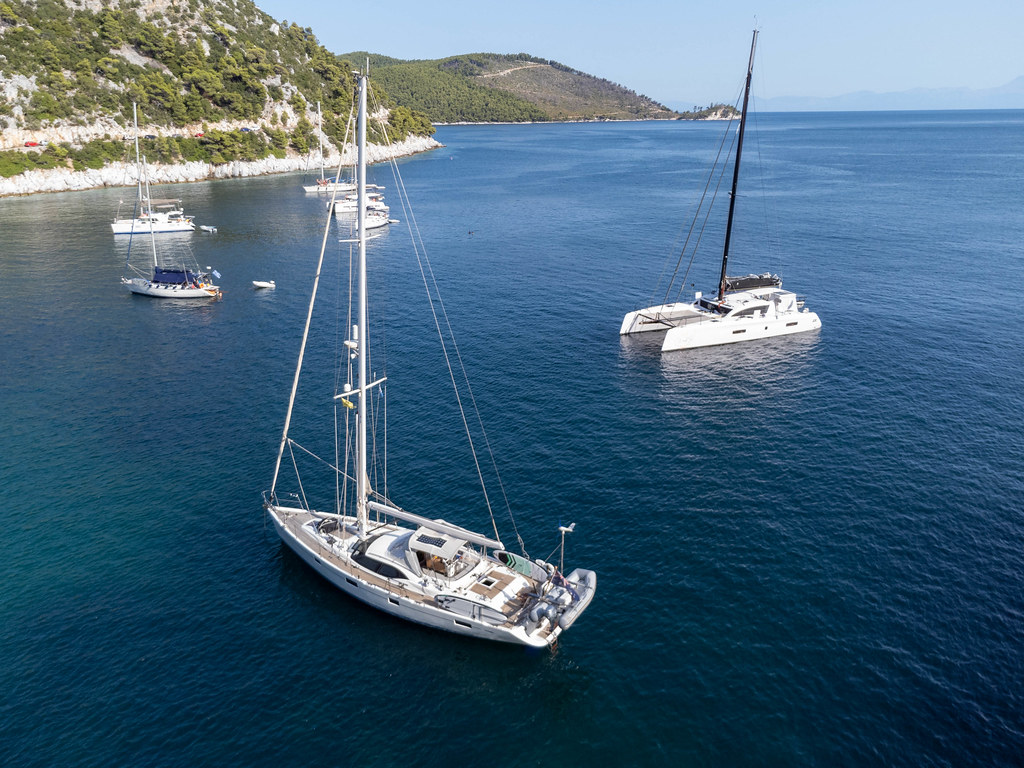 Sailing boats in the popular Limnonari bay on Skopelos. Summer holiday 2021 in Greece