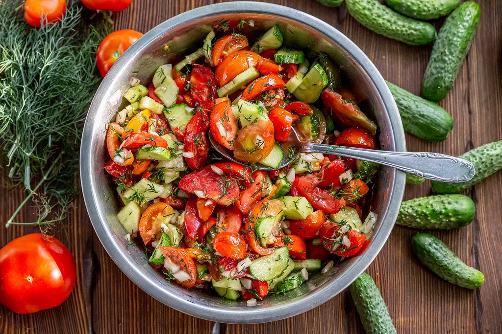 Salad with cucumbers, tomatoes, onions, dill with soy sauce and sunflower oil