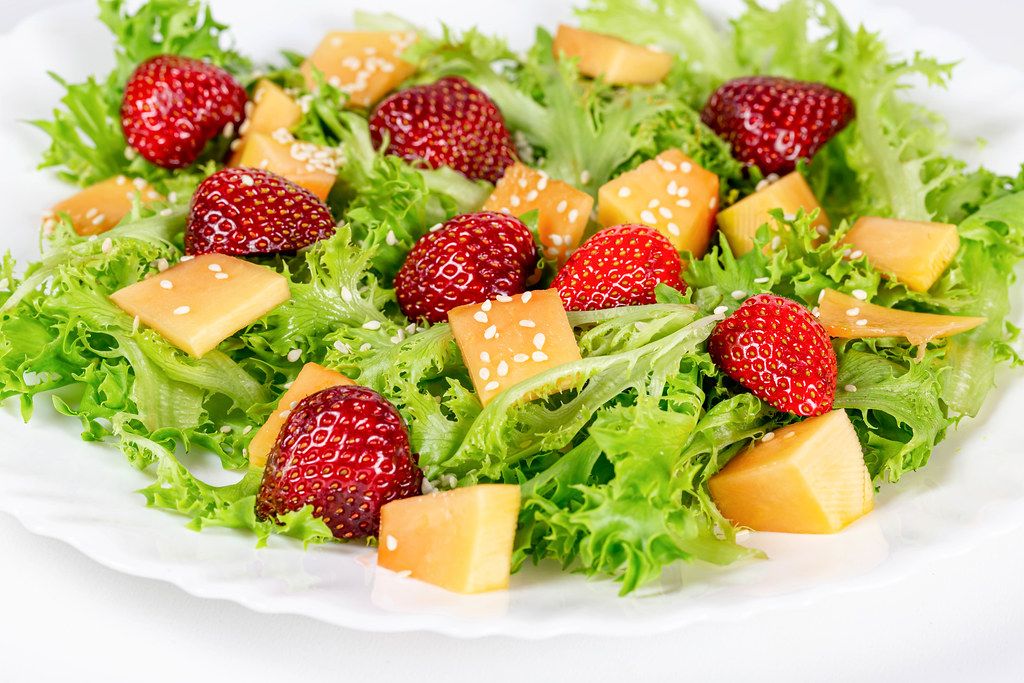 Salad with lettuce leaves and fruit slices