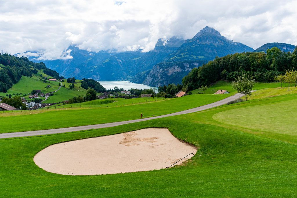 Sand bunker of a golf club overlooking beautiful Swiss mountains and the lake Lucern