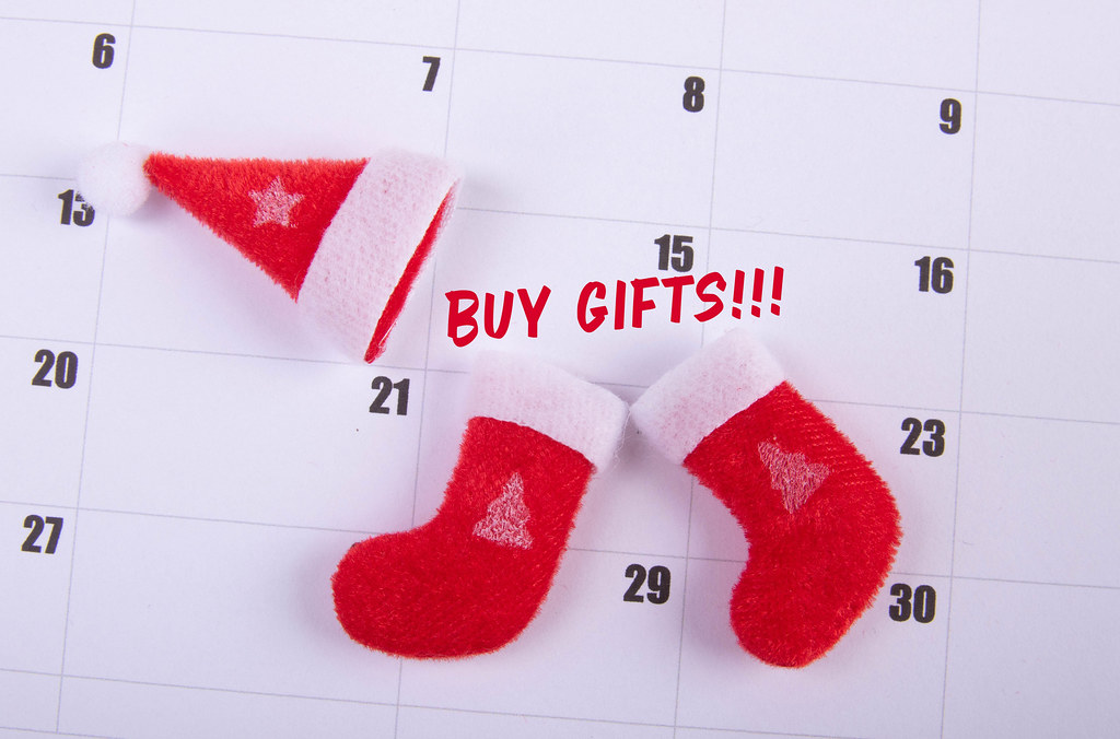 Santas Claus hat and socks with Buy Gifts text on the calendar