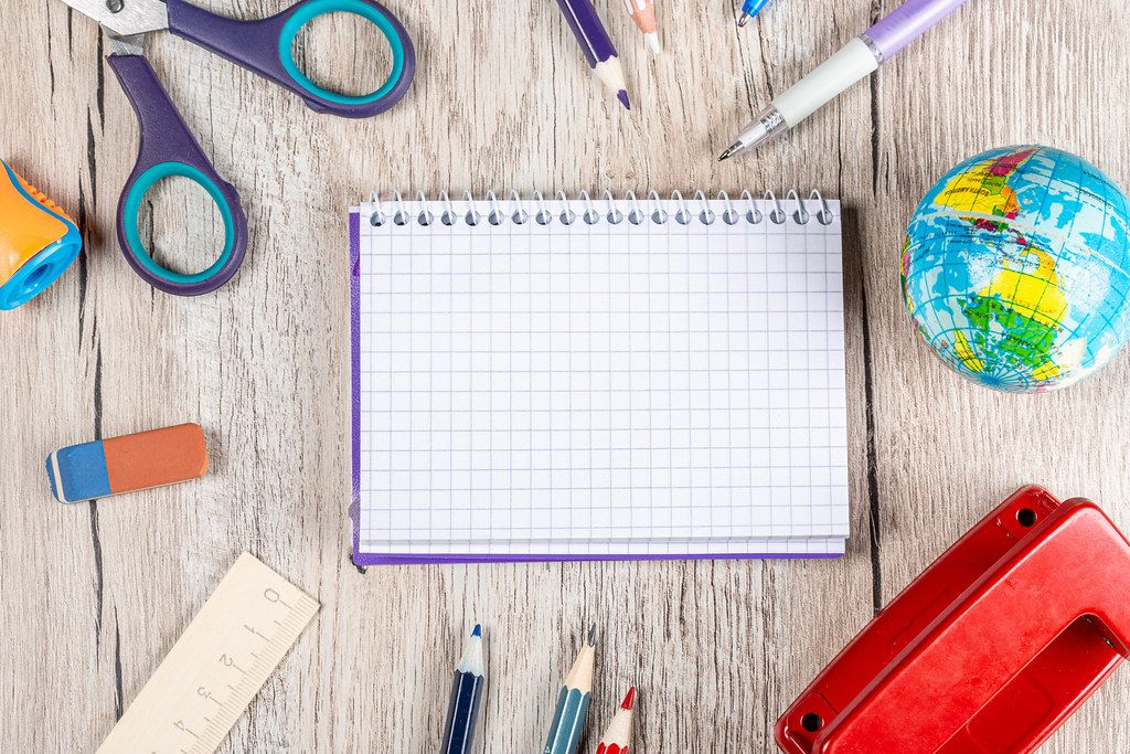 School supplies on a wooden background, top view