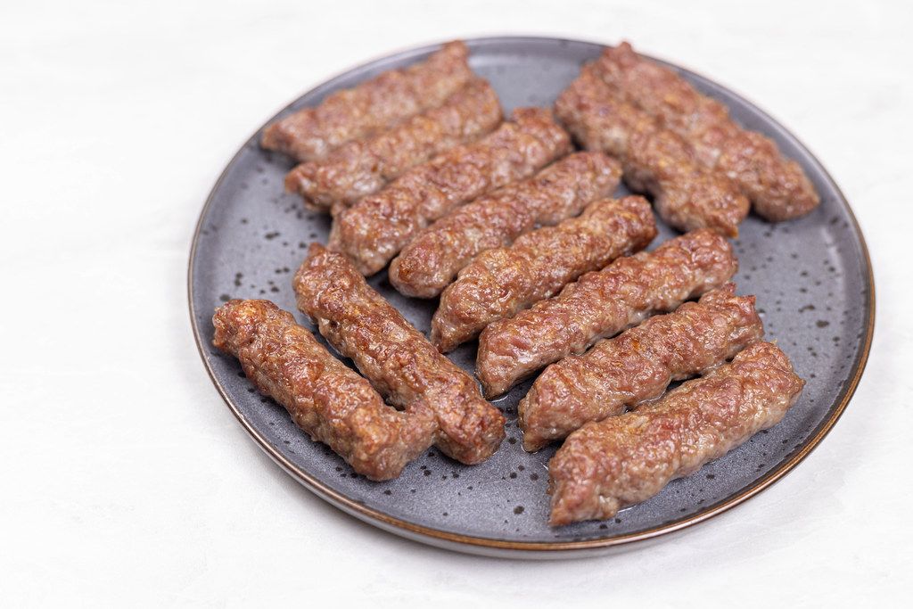 Served fried Kebabs on the plate above white background