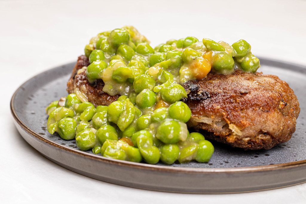 Served Meatballs with cooked Green Peas