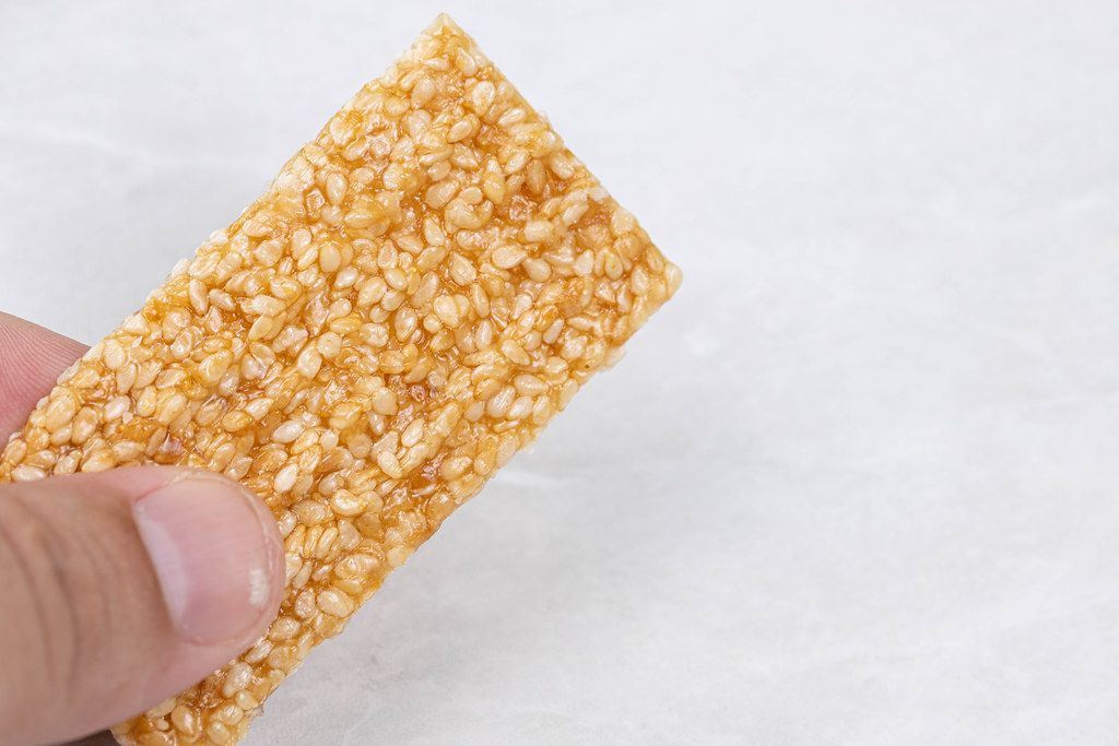 Sesame Bar in the hand with copy space