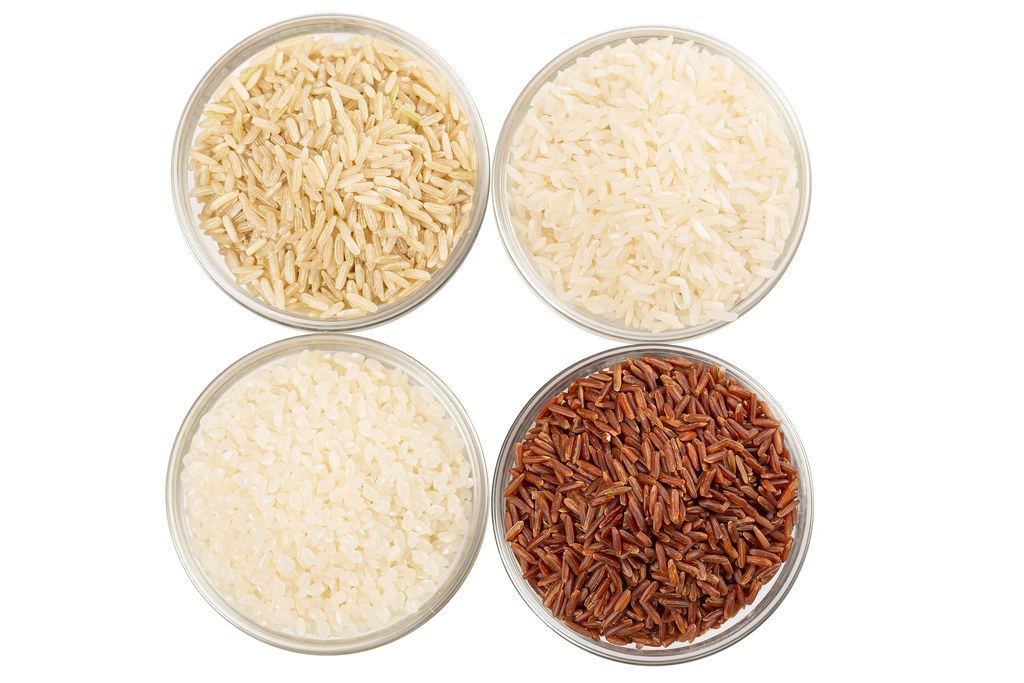 Set of four types of rice in glass bowls, top view