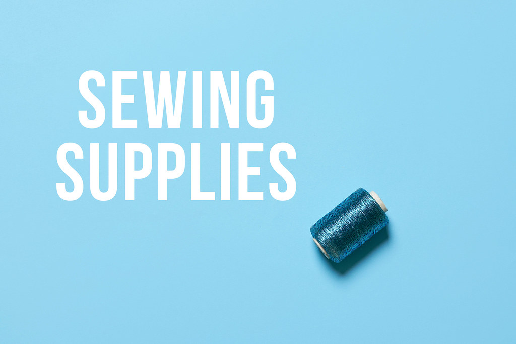 Sewing supplies - a spool on blue background