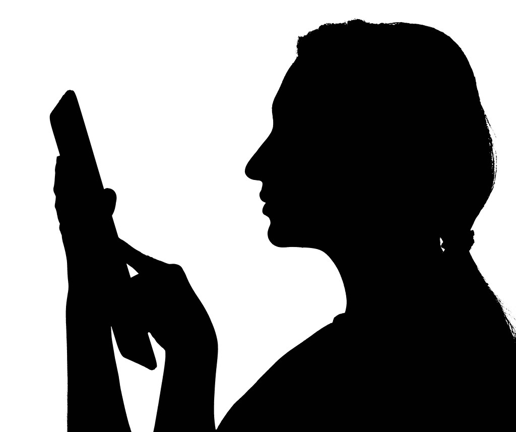 Shadow of a woman using a tablet