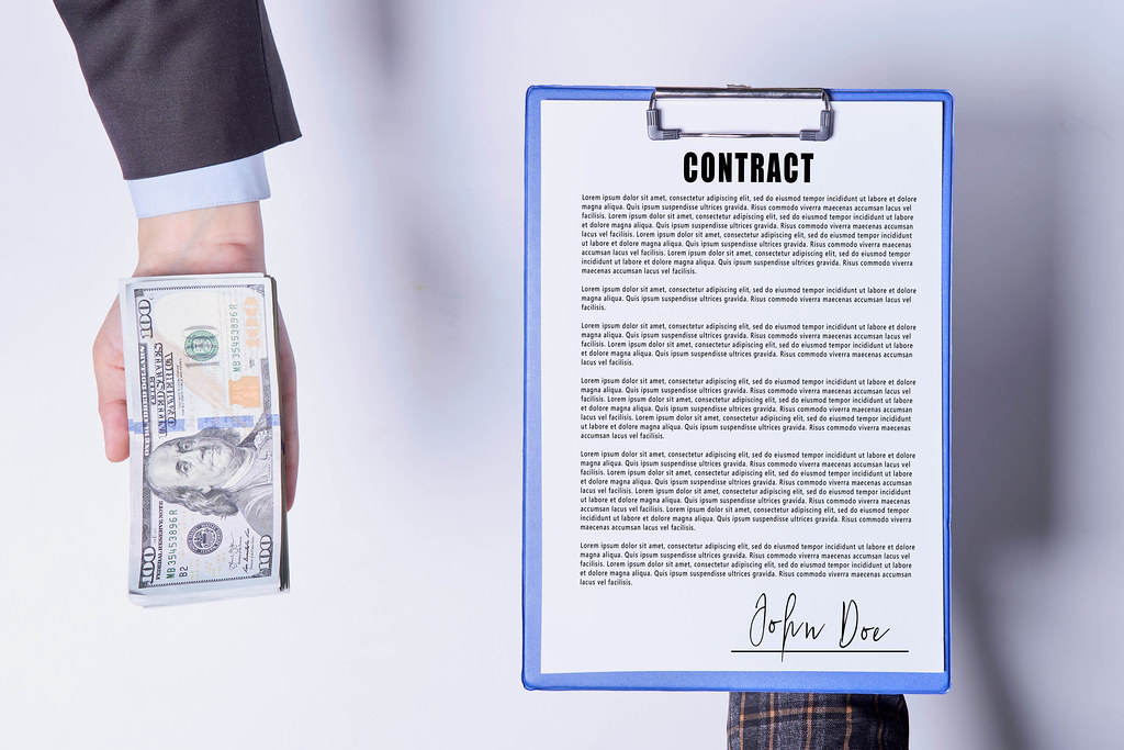 Sign contract for a bribe. Cheating, corruption, bribery concepts
