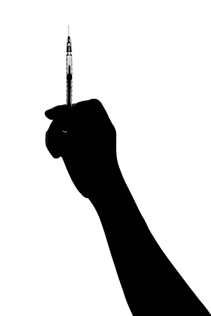 Silhouette of doctor hand with a syringe isolated on white background