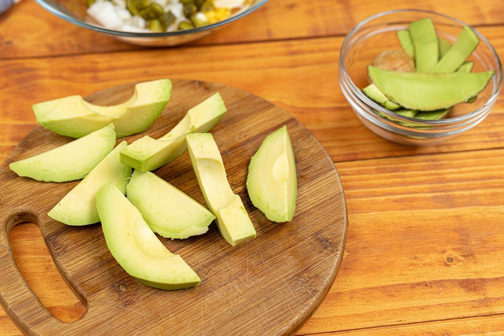 Sliced Avocado on the round wooden board