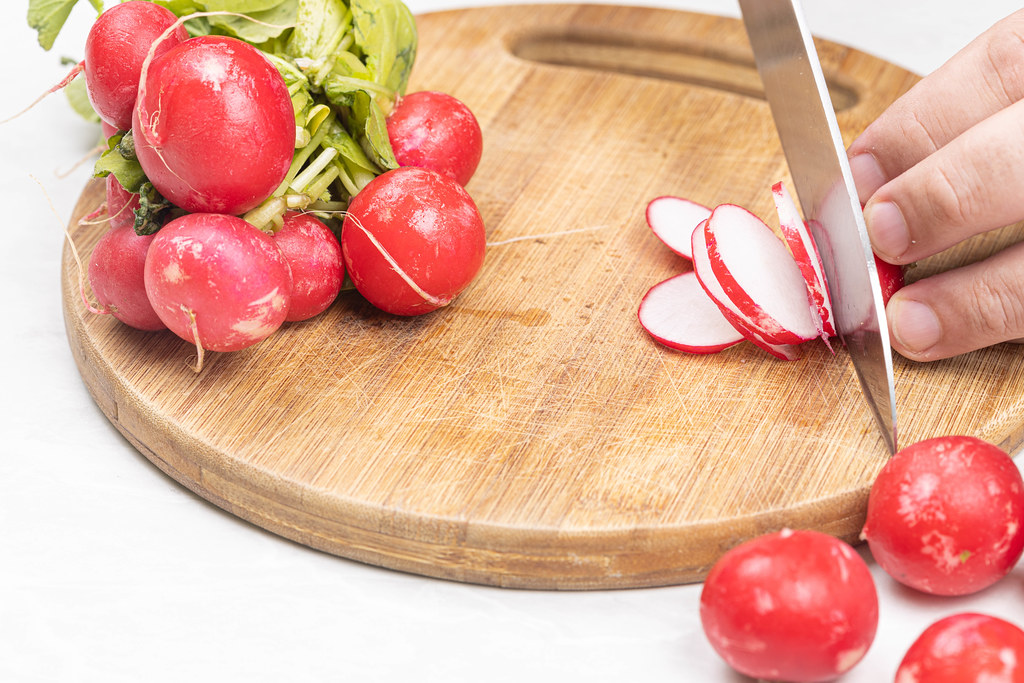 Slicing Red Radishes on the cutting board