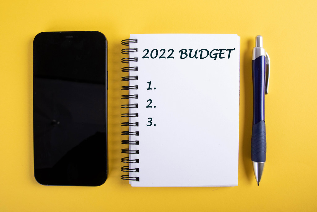 Smartphone and notebook with 2022 Budget text on yellow background