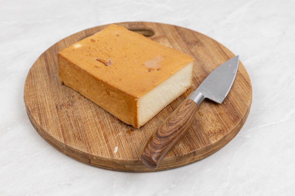 Smoked Cheese on the round wooden board