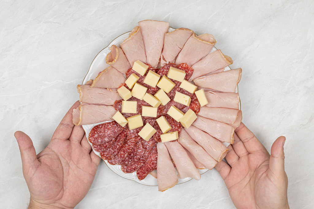 Smoked Meat and Sausages served with Cheese on the plate