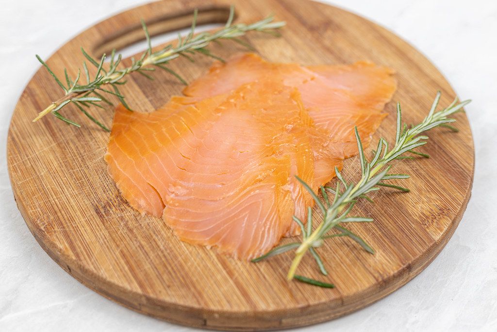 Smoked Salmon with Rosemary branches on the wooden board
