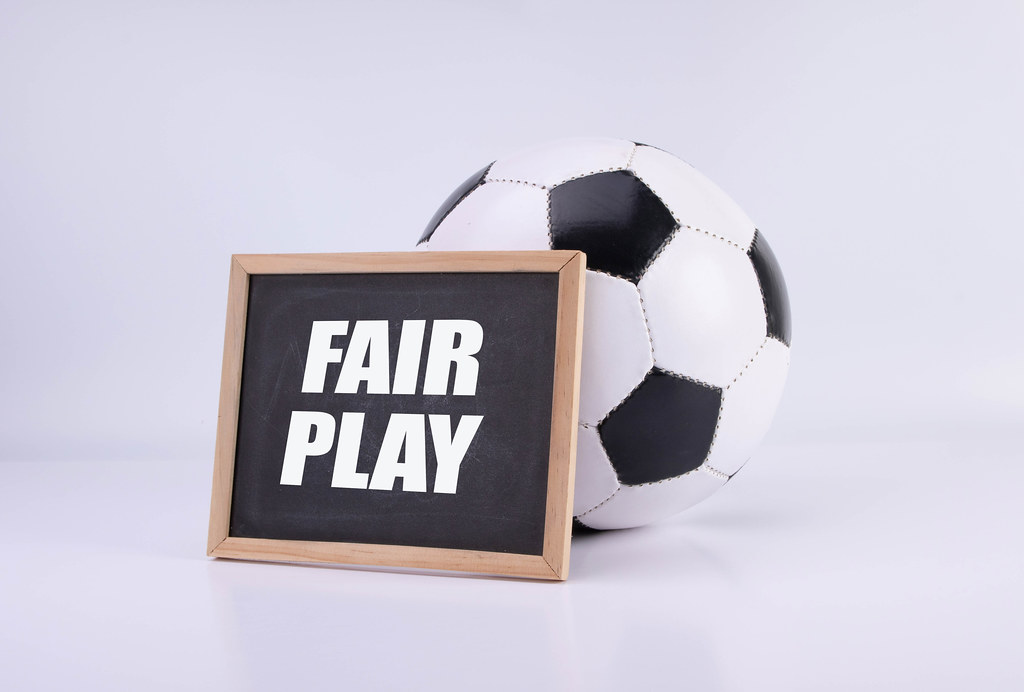 Soccer ball and chalkboard with Fair play text