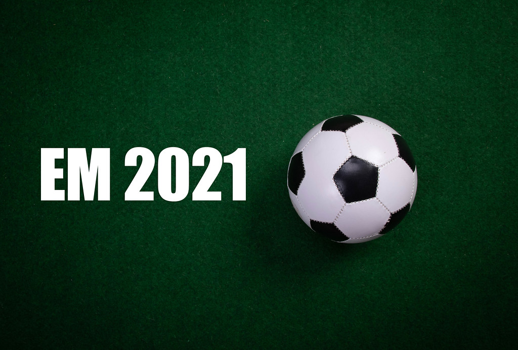 Soccer ball and EM 2021 text on green grass