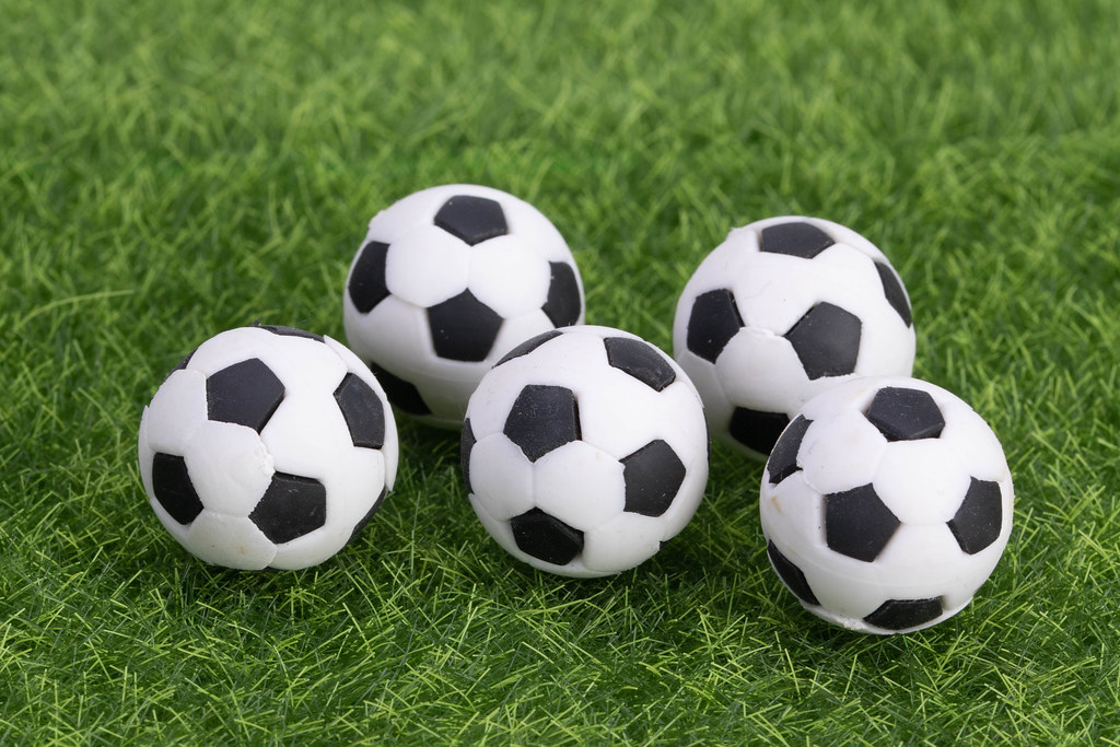 Soccer balls on green grass