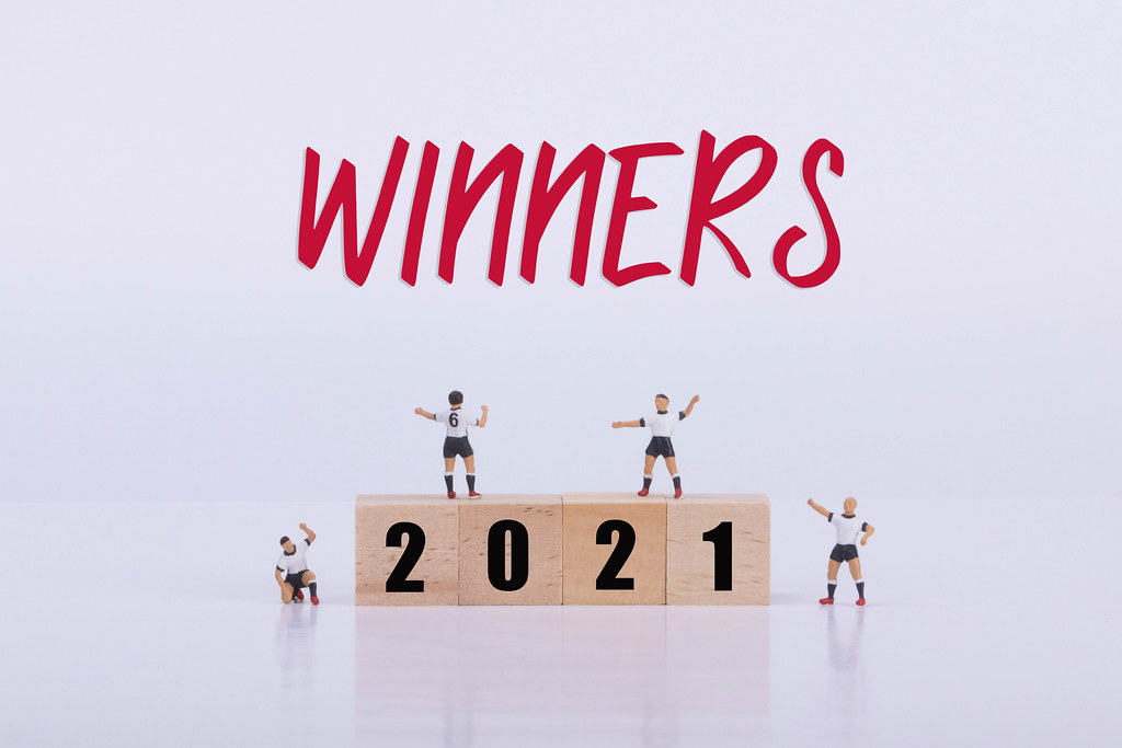 Soccer players standing on wooden cubes with 2021 text and Winners text