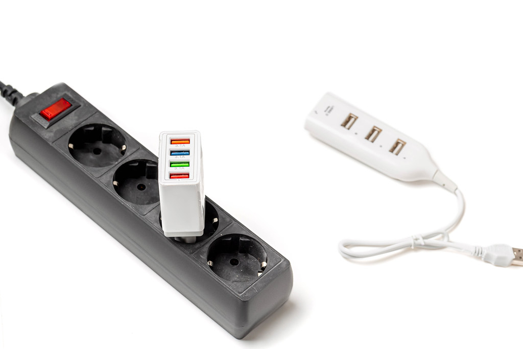 Sockets and battery charger on white