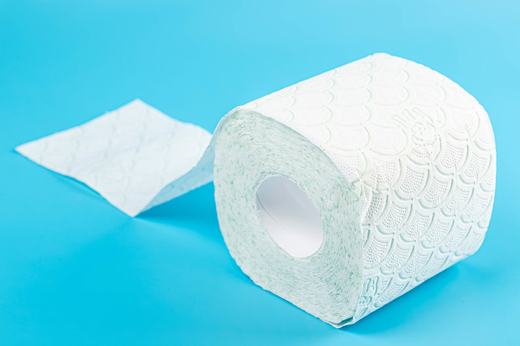 Soft toilet paper on blue background