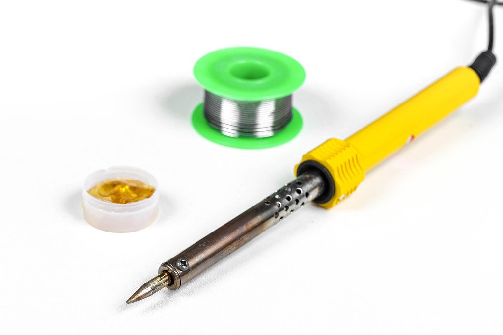 Soldering iron, tin and rosin on a white background