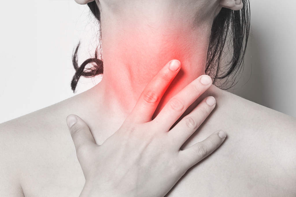 Sore Throat - A woman hands touching her neck