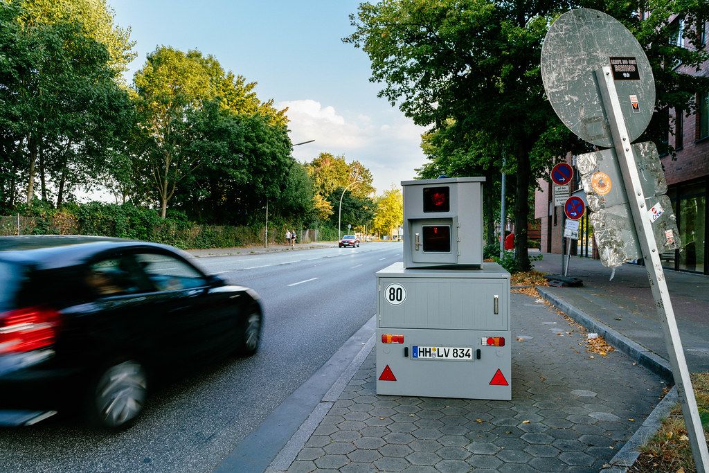 Speeding car passing portable speed control unit on the street