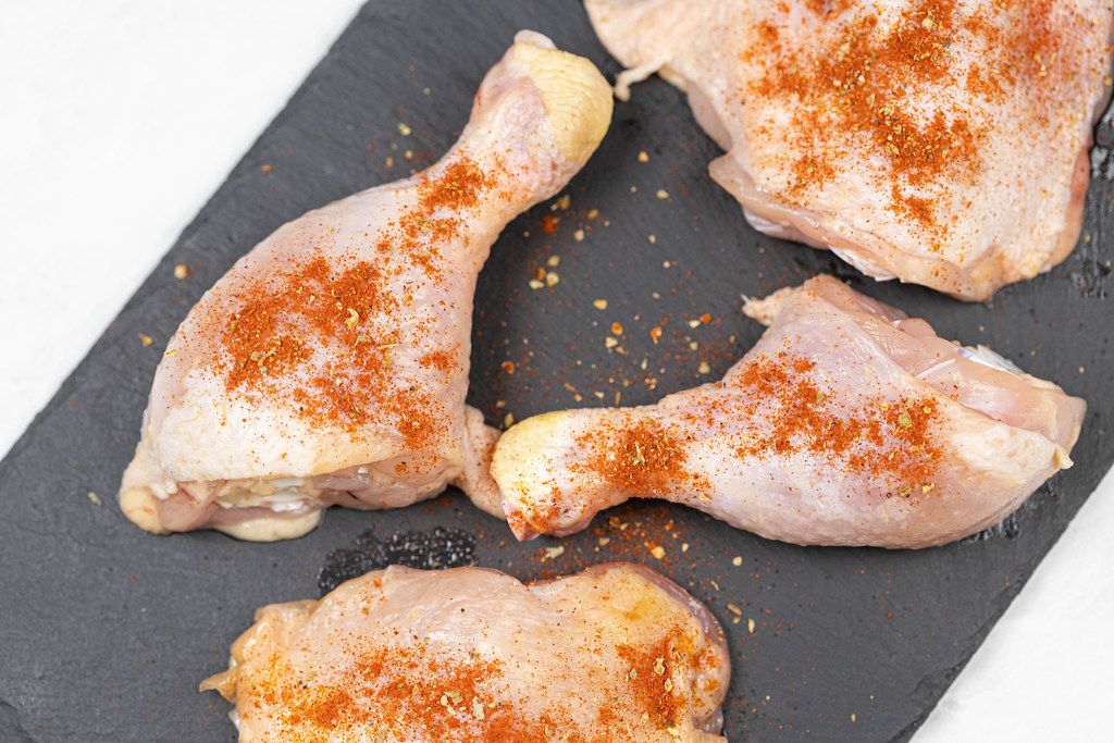 Spiced Chicken Drumsticks with Paprika on the black stone tray