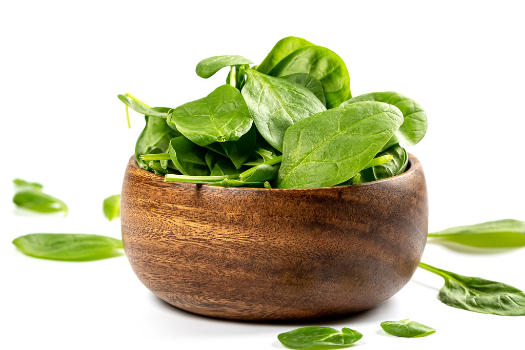 Spinach leaves in a wooden bowl
