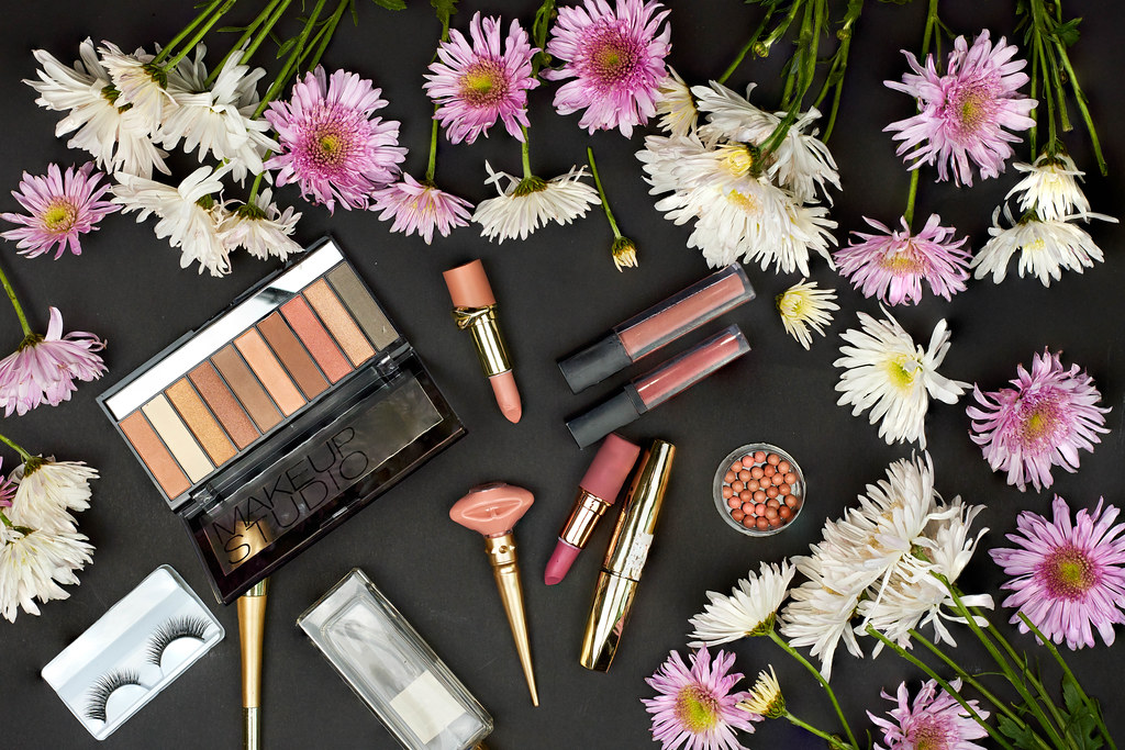 Spring flowers and beauty tools on dark background