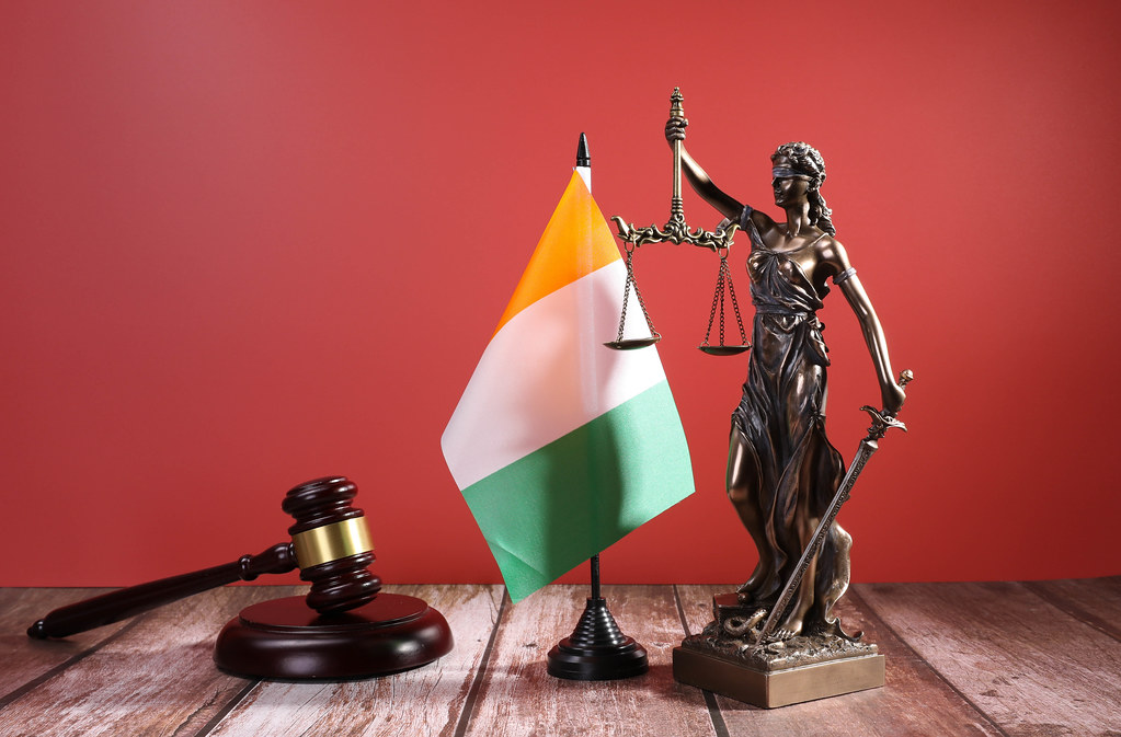 Statue of Lady Justice with Judge gavel and flag of Ireland