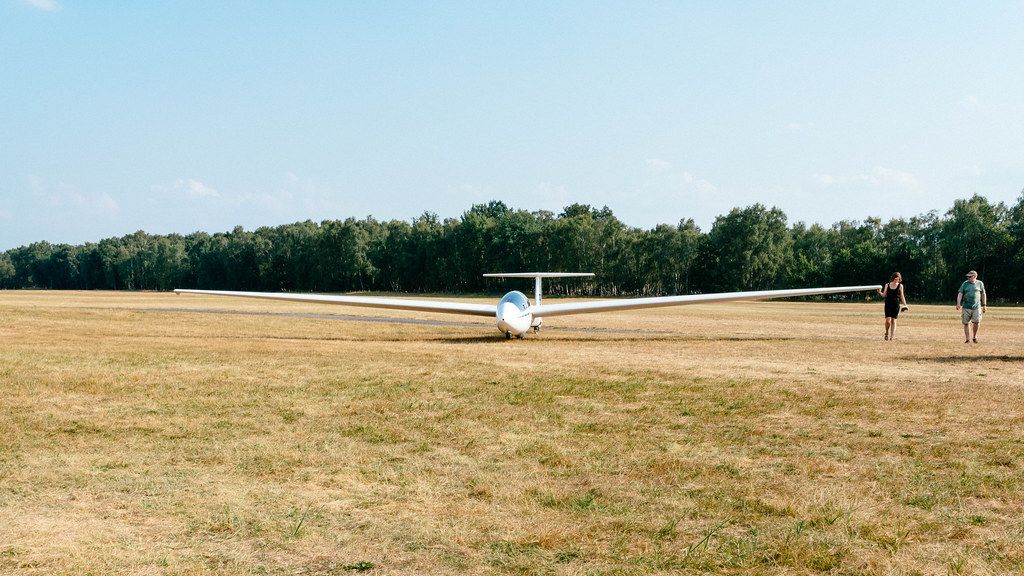 Student rolling her glider back to the start position at the airfield