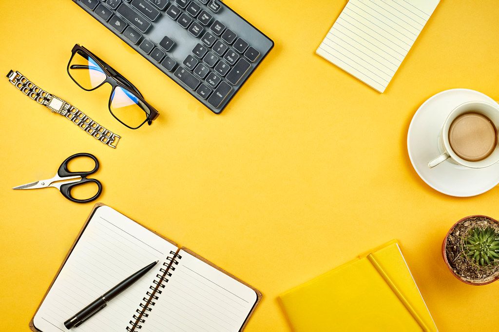 Stylish yellow workspace with office supplies