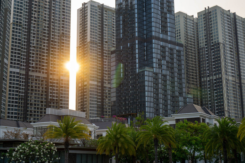 Sunset behind Vinhomes Apartment Buildings and Vincom Landmark 81 Skyscraper with Villas in the Foreground in Saigon, Vietnam