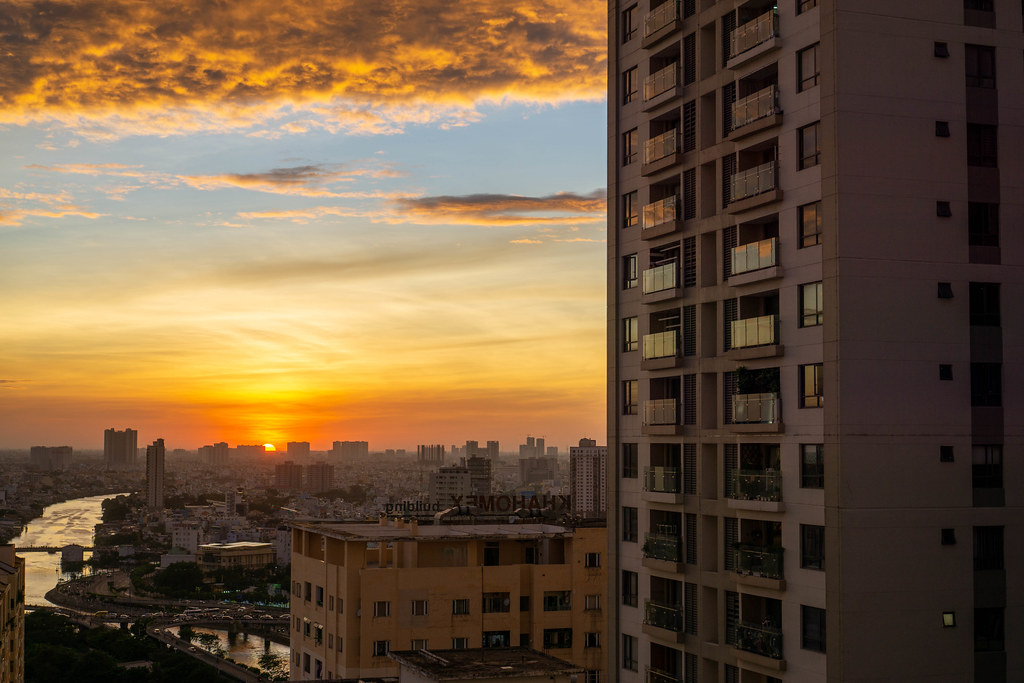 Sunset View of Ho Chi Minh City from a Balcony of an Apartment Building with Huge Cloud in the Sky in Saigon, Vietnam