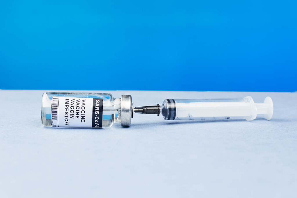 Syringe and vial of vaccine for flu, covid-19, measles or other diseases