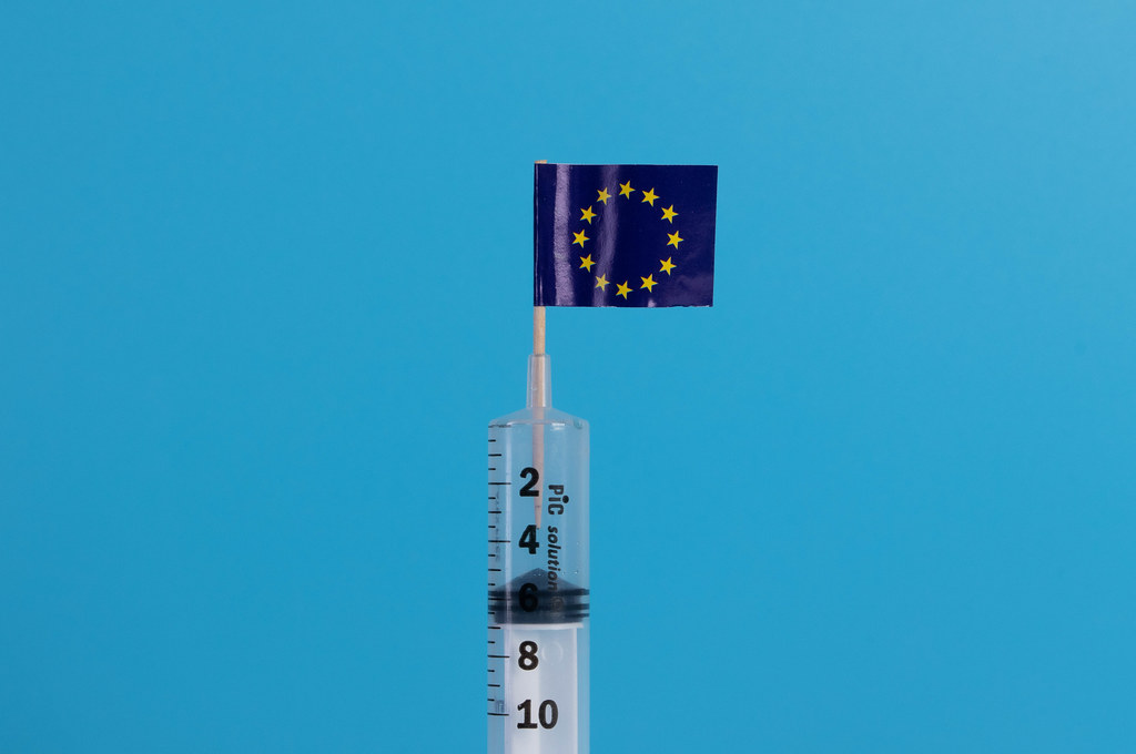 Syringe with flag of Europeand Union on blue background
