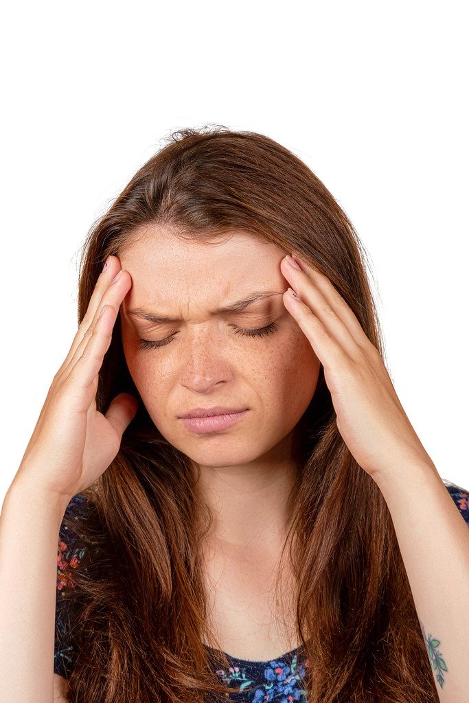 Teen woman with headache holding her hand to the head